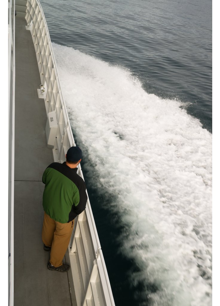 speeding-ferry-boat-wake-of-ocean-spray-man-lookin-2024-09-18-04-22-01-utc