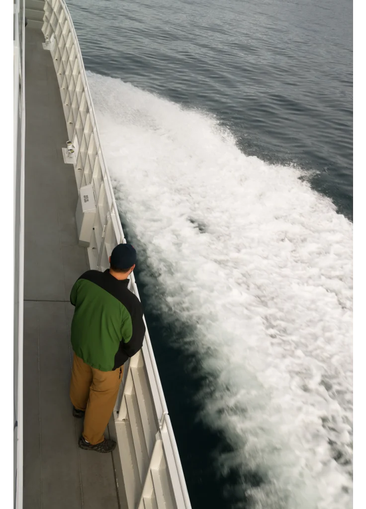 speeding-ferry-boat-wake-of-ocean-spray-man-lookin-2024-09-18-04-22-01-utc