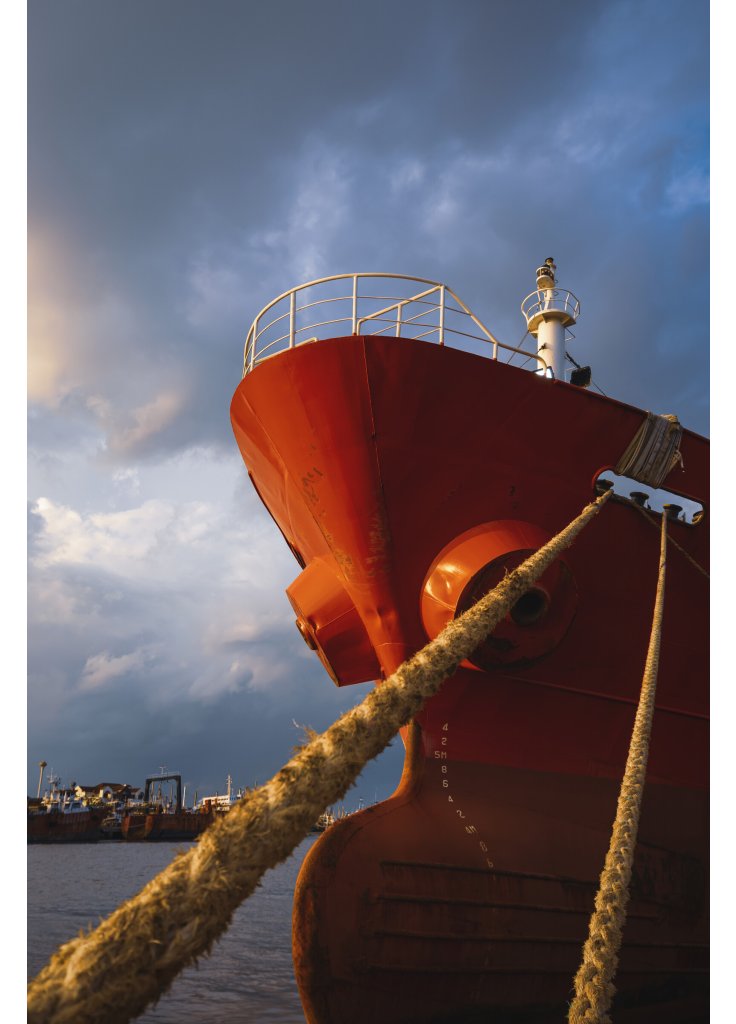 cargo-ship-docked-at-port-against-rain-cloudy-sky-2025-03-11-00-58-23-utc