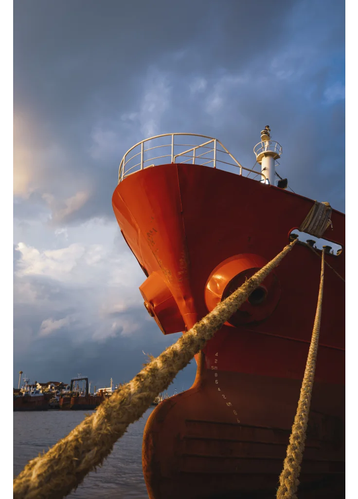 cargo-ship-docked-at-port-against-rain-cloudy-sky-2025-03-11-00-58-23-utc